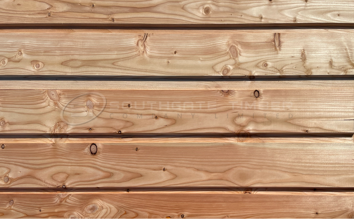 Close-up view of Southgate Timber’s European Larch 20 x 144mm ST1 cladding, showing smooth planed boards with natural grain patterns and warm golden-brown tones.