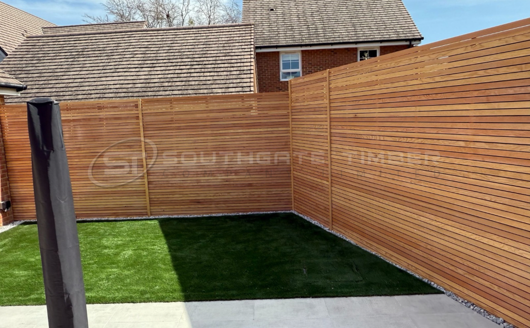 Douglas Fir horizontal slatted timber fencing installed in modern garden