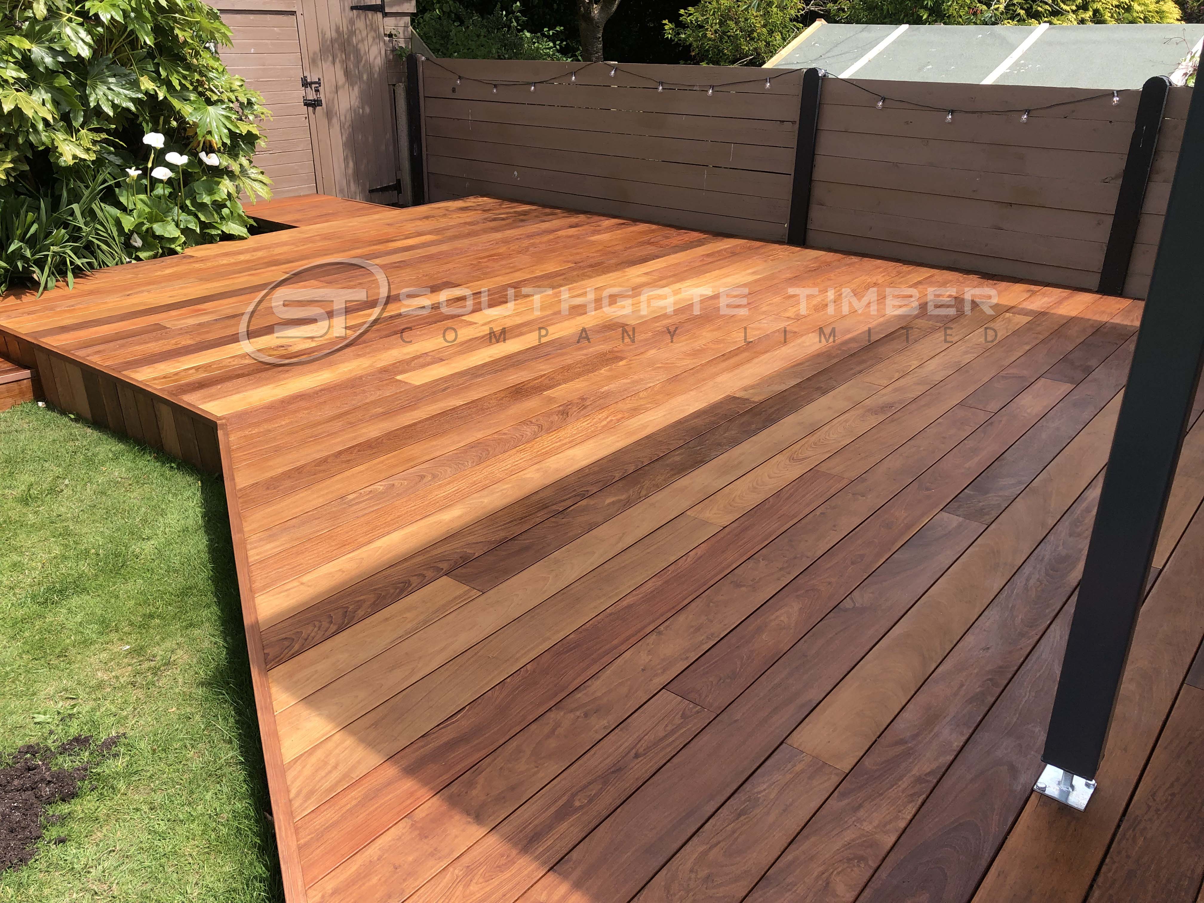Durable, hard-wearing Ipe Hardwood decking with excellent stability, long-lasting, installed with hidden fixings for modern, clean finish in this home renovation featuring decking area in garden