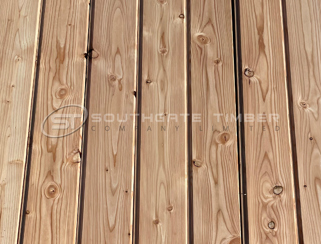 Close-up image of Larch 20 x 144mm T.G.V. ST1.L cladding boards showing the natural grain, knots and warm reddish-brown tones of the timber. Vertical tongue-and-groove profile supplied by Southgate Timber.