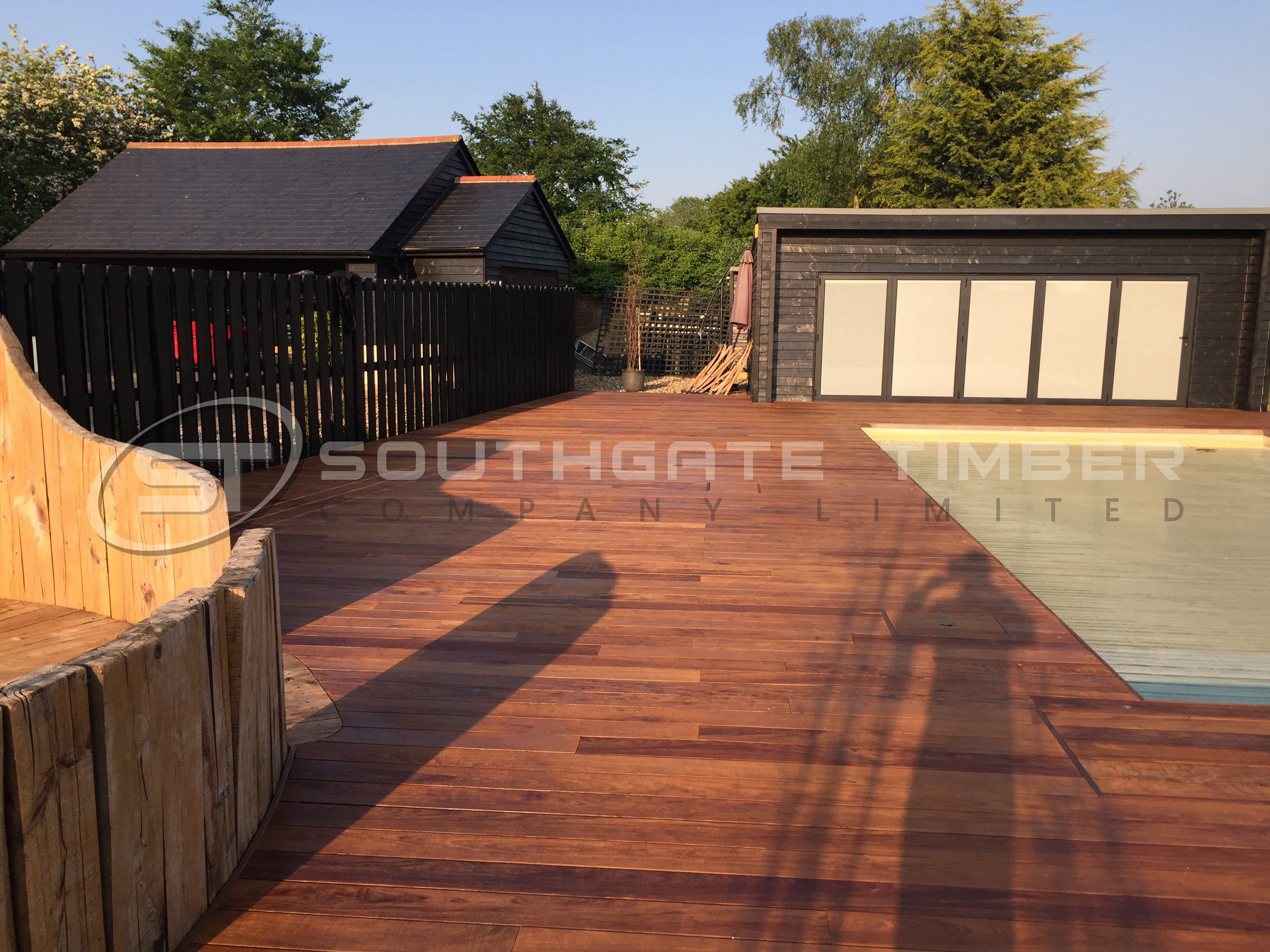 Ipe hardwood decking 21 x 145mm hidden fixings, durable and hardwearing decking. Poolside decking design in garden, garden decking goals and inspiration. Premium decking choice one of the top 5 decking choices in UK 2025