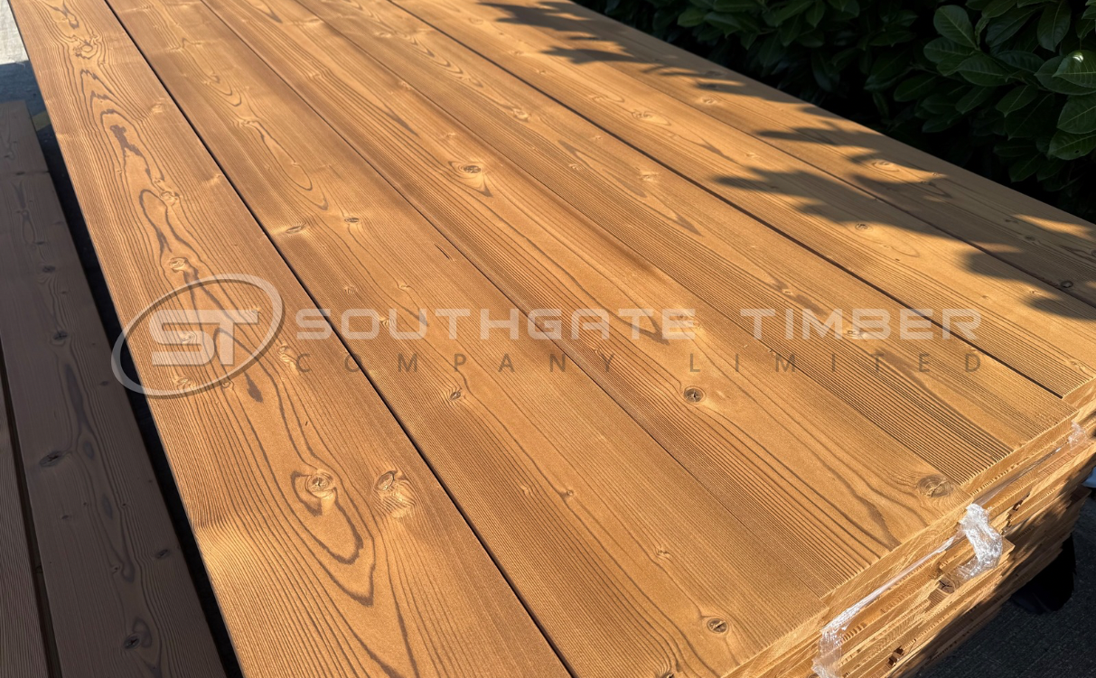 Thermowood pine softwood decking boards with natural grain and warm brown colour