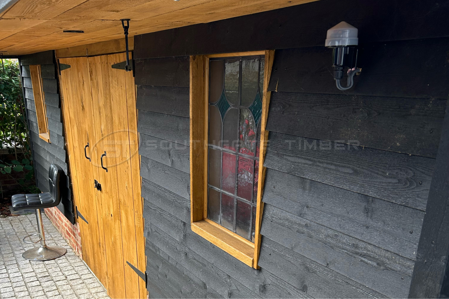 Black barn style timber cladding with durable low maintenance exterior finish and contrasting natural timber details