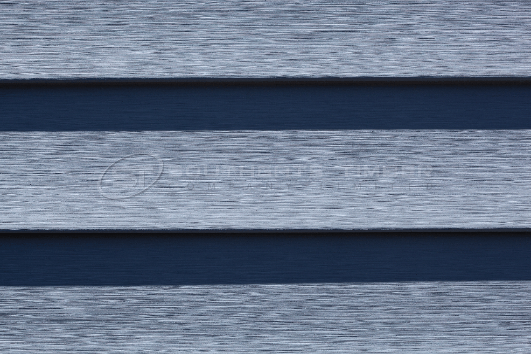 Close-up of composite cladding showing manufactured woodgrain texture and contemporary horizontal profile.