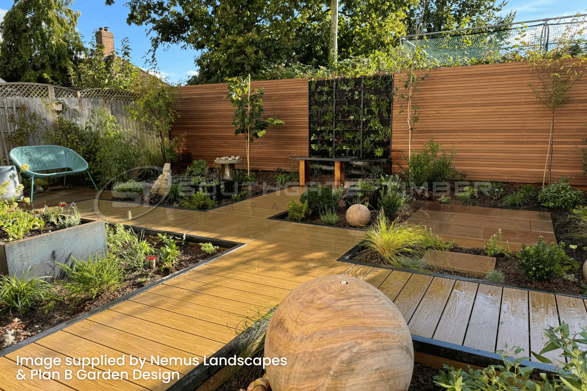 Thermo Ayous slatted fencing installed in a contemporary landscaped UK garden with modern timber decking and planting design
