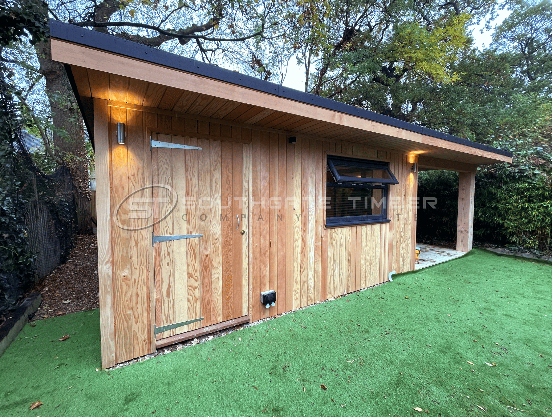 Douglas Fir timber cladding on a garden room outbuilding in a UK garden