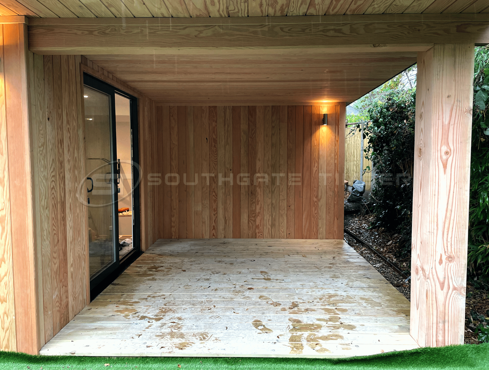 Douglas Fir cladding used on a contemporary garden room with covered outdoor seating area, highlighting the natural appearance and longevity of Douglas Fir timber.