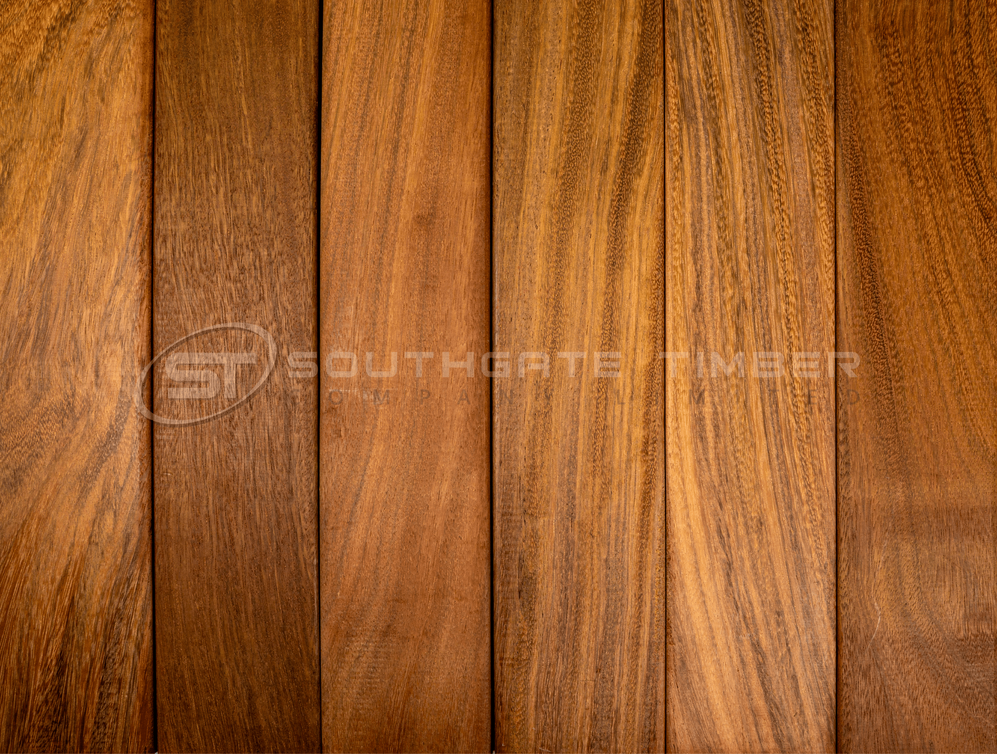 Close-up of Tali hardwood decking boards showing rich reddish-brown colour and striped grain pattern