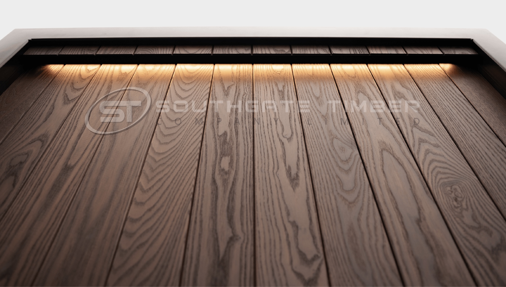 Close-up of Thermo-Ash cladding showing the fine grain and rich brown colour of thermally modified hardwood.