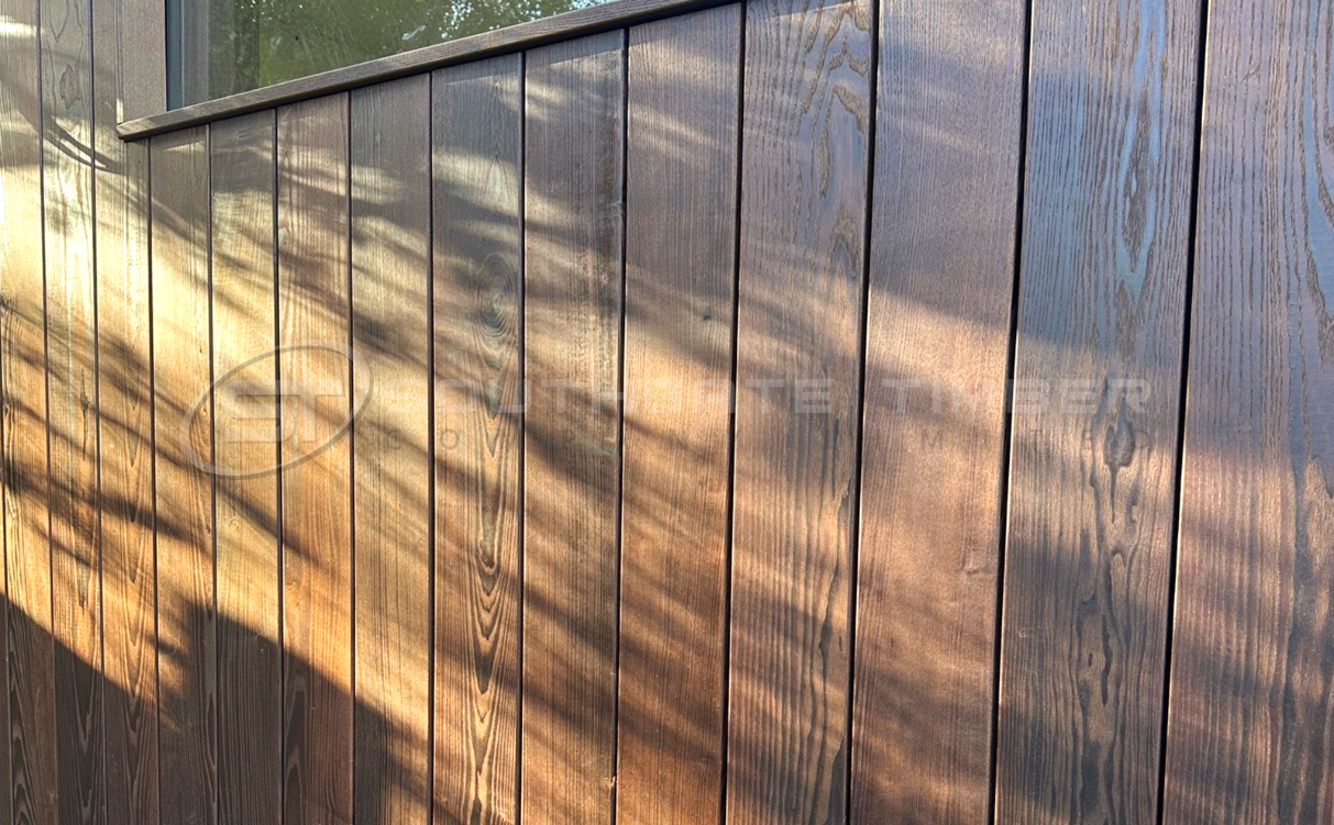 Thermo-ash timber cladding installed vertically showing rich dark tones and natural grain, a durable and stable hardwood option for exterior cladding