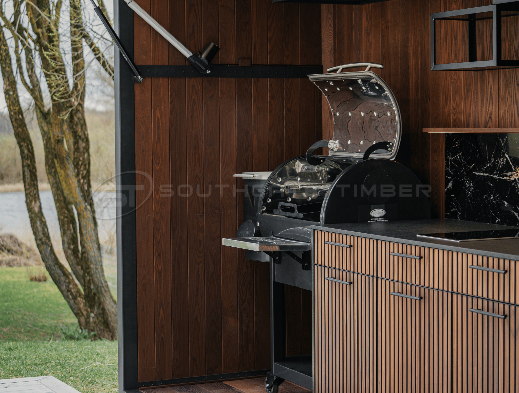 Thermo-Ash timber cladding on modern outdoor kitchen with architectural exterior design