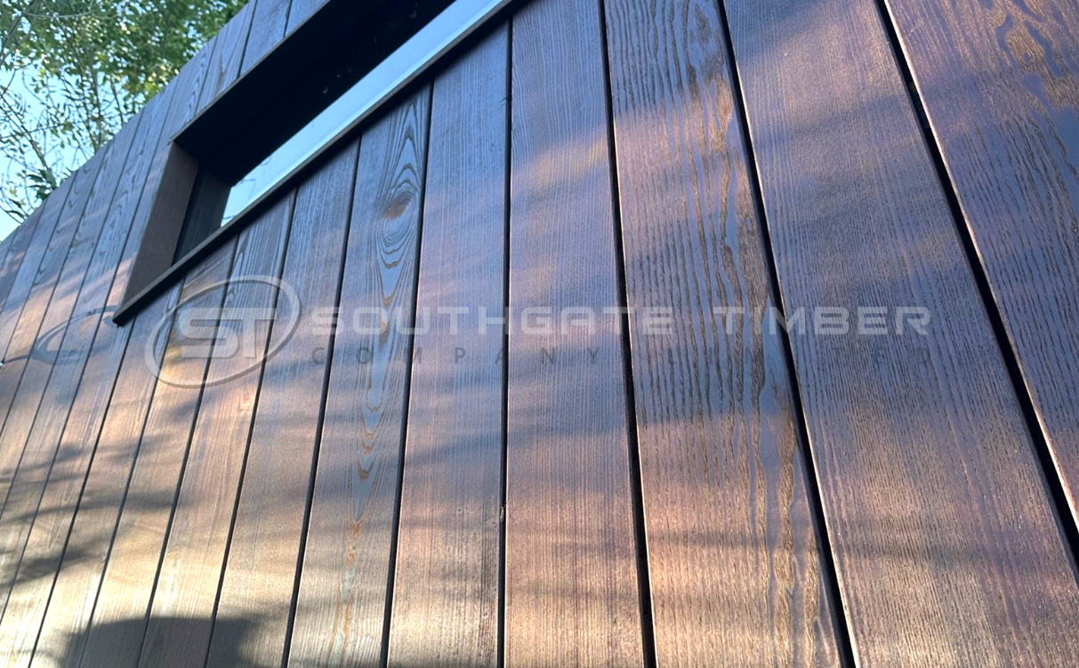 Thermo-ash cladding installed on exterior wall showing smooth finish and natural grain