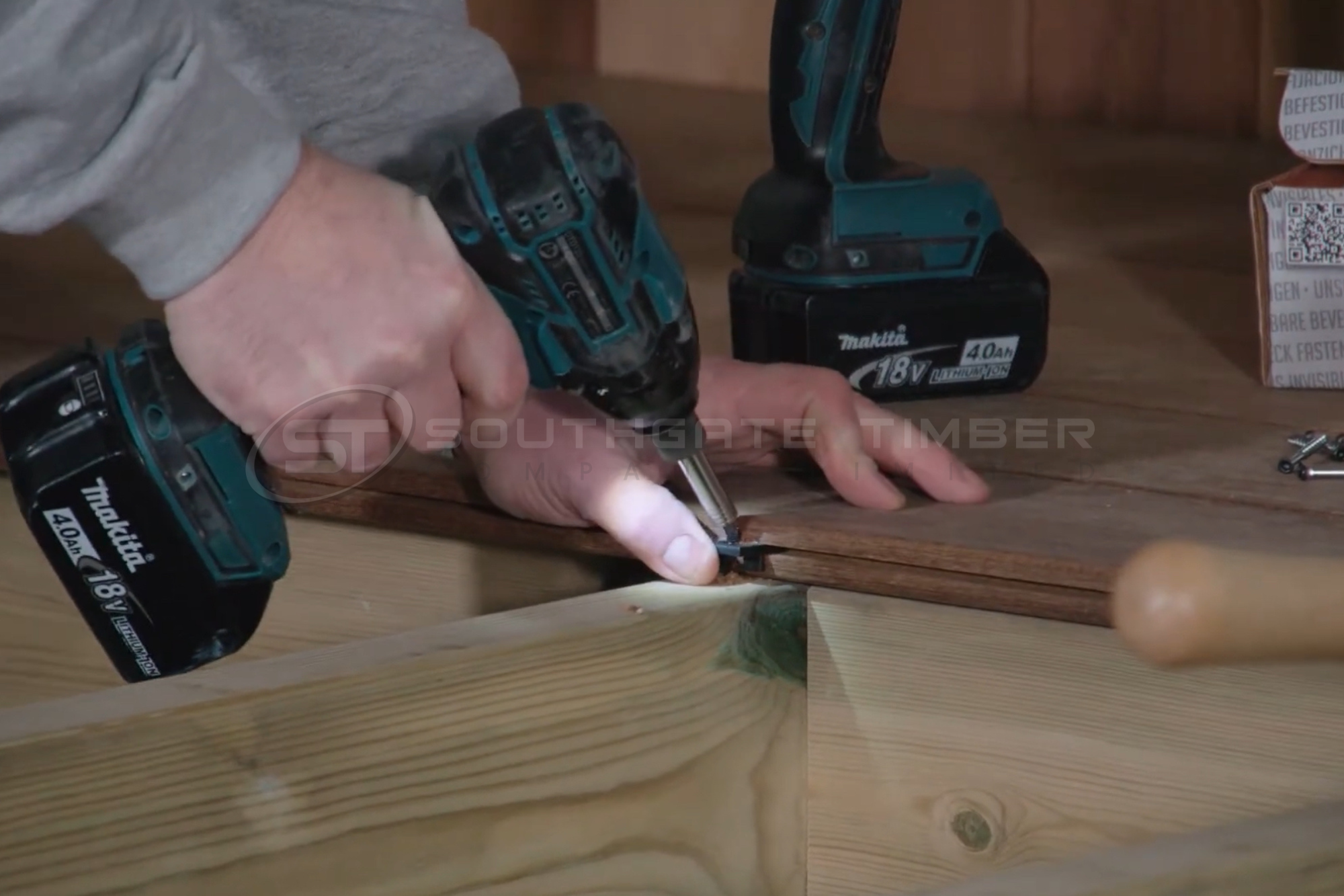 Close up of hidden fix decking installation showing clip system and fixing process
