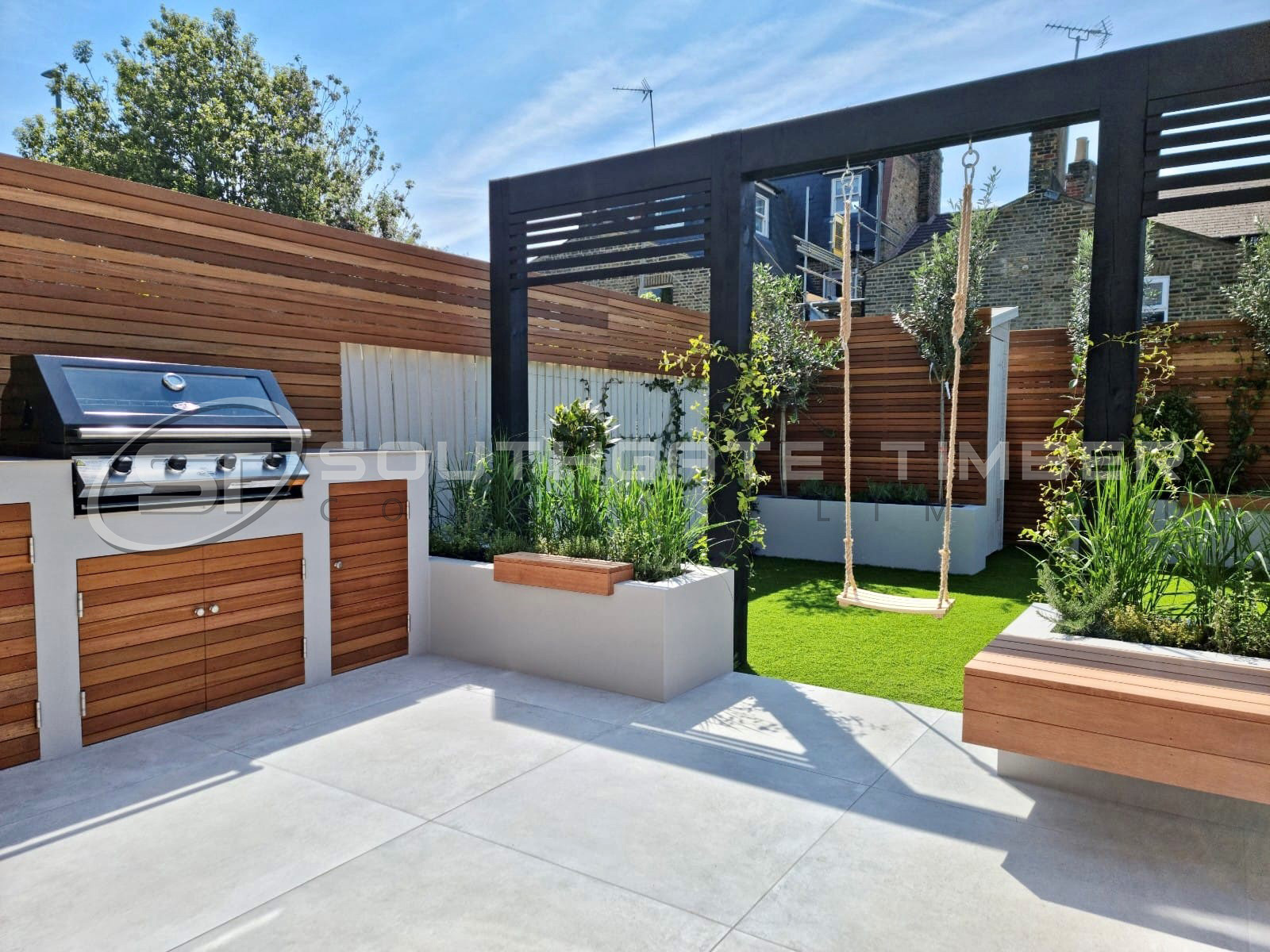 Yellow Balau screening and outdoor kitchen cabinetry used within a contemporary garden entertaining space