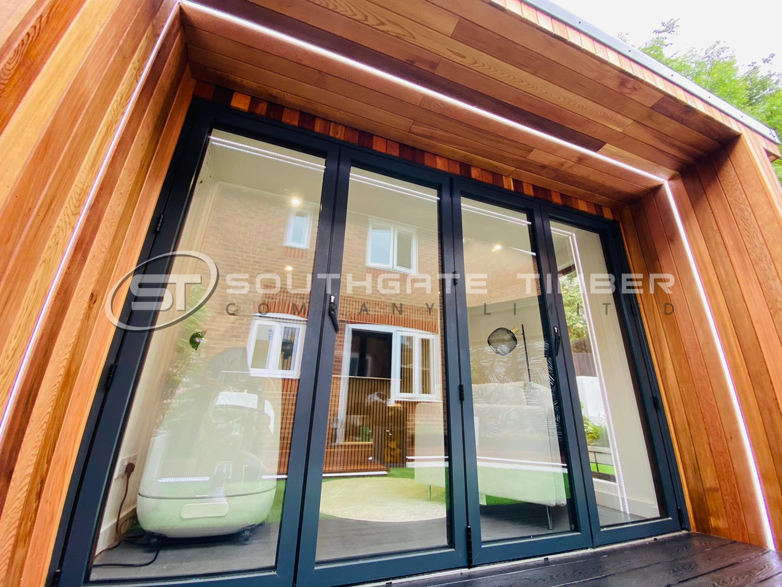 Western Red Cedar cladding on a modern garden room with black bi-fold doors