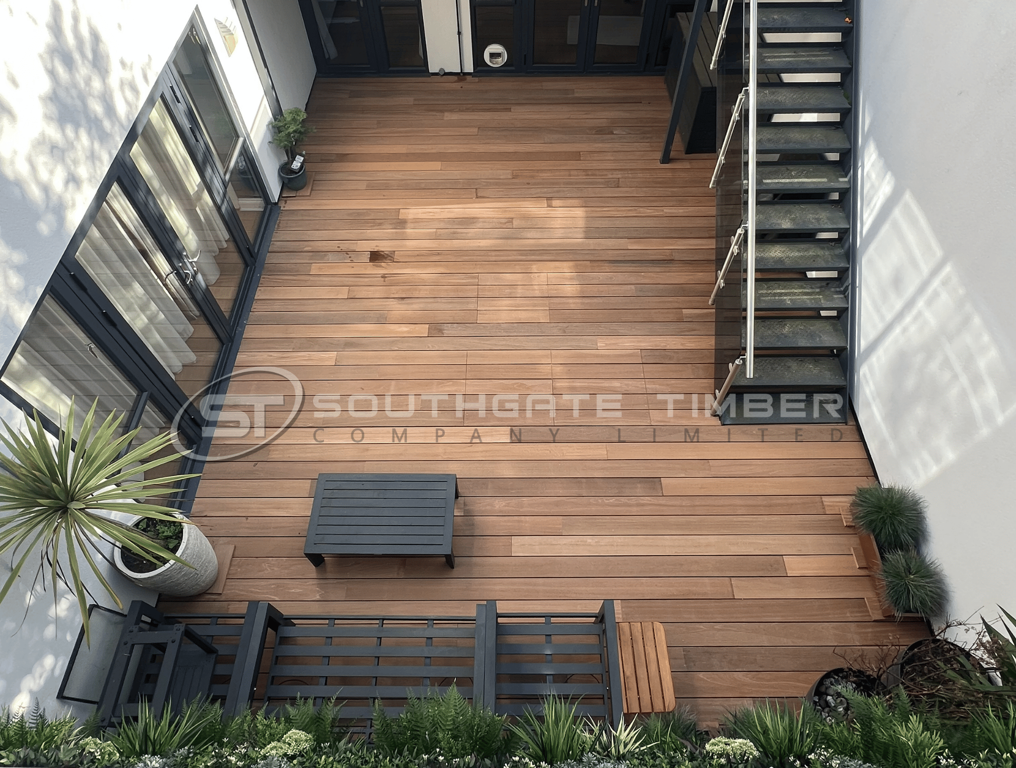 Yellow Balau hardwood decking installed on a garden terrace, birds-eye view