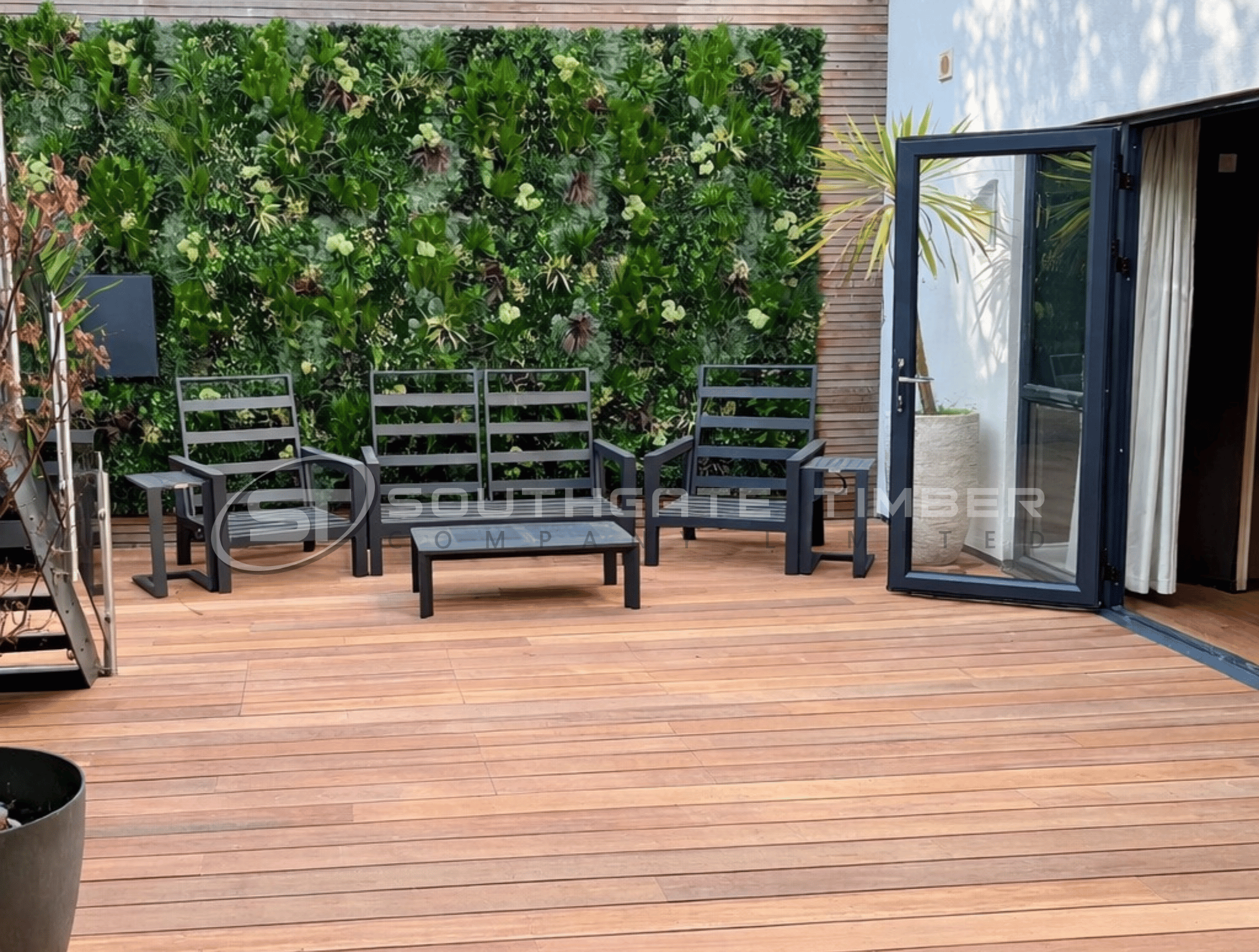 Yellow Balau hardwood decking on a rooftop terrace with outdoor seating and living plant wall